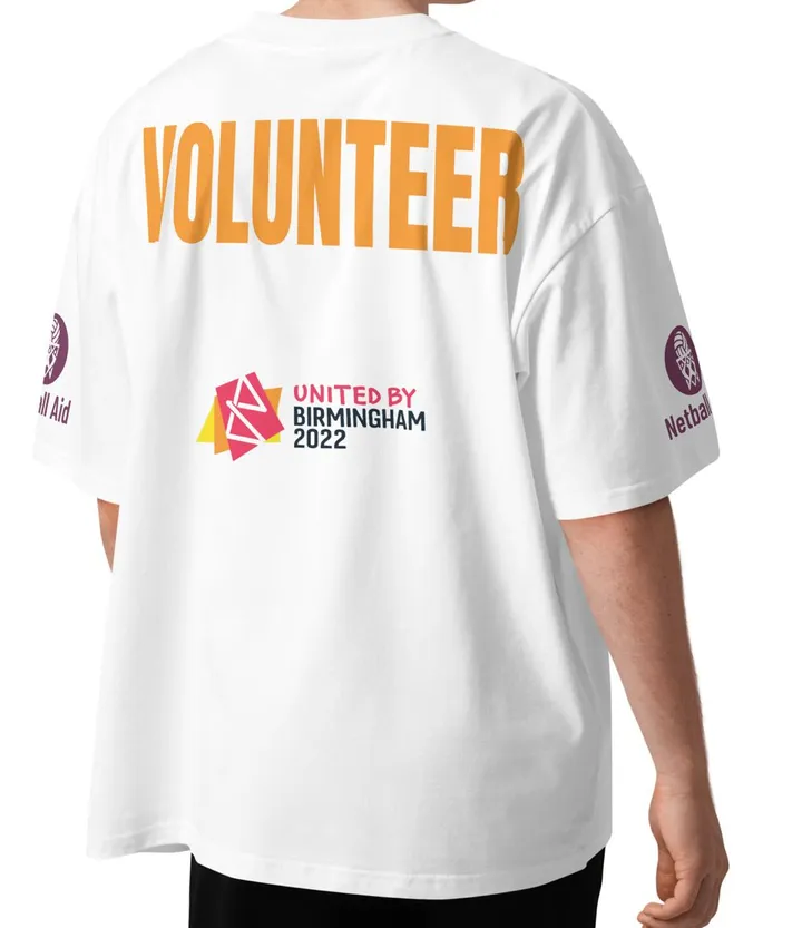 Back of the volunteer T-shirt: white, VOLUNTEER in big orange letters, Netball Aid logo on each sleeve