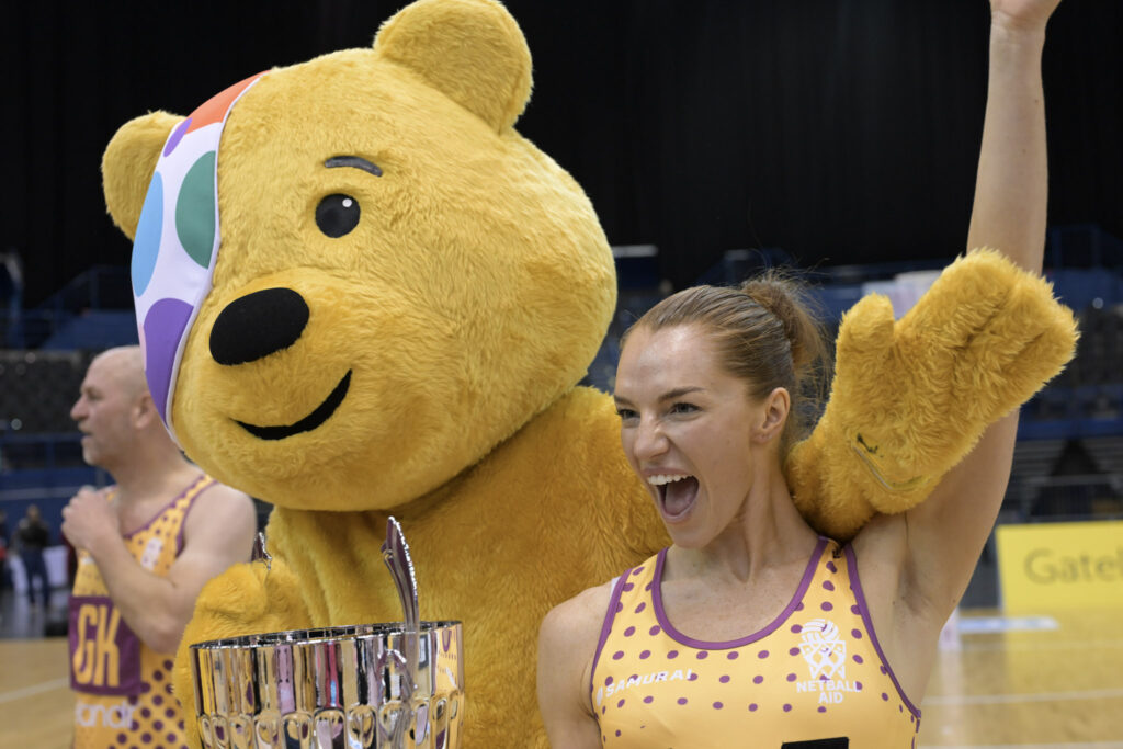 Pudsey Bear celebrates with a Netball Aid player